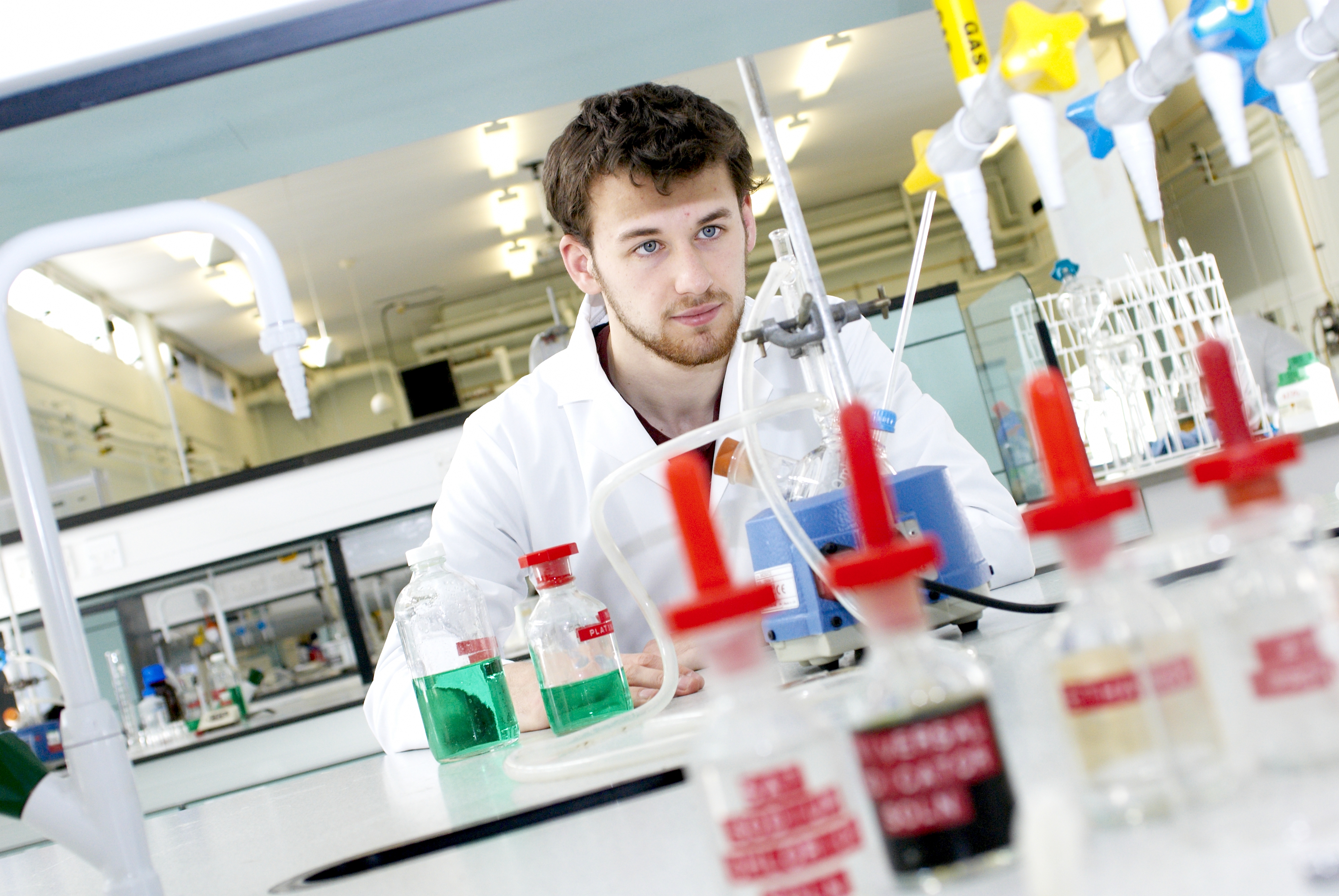 Student working in pharmacy laboratory with science equipment