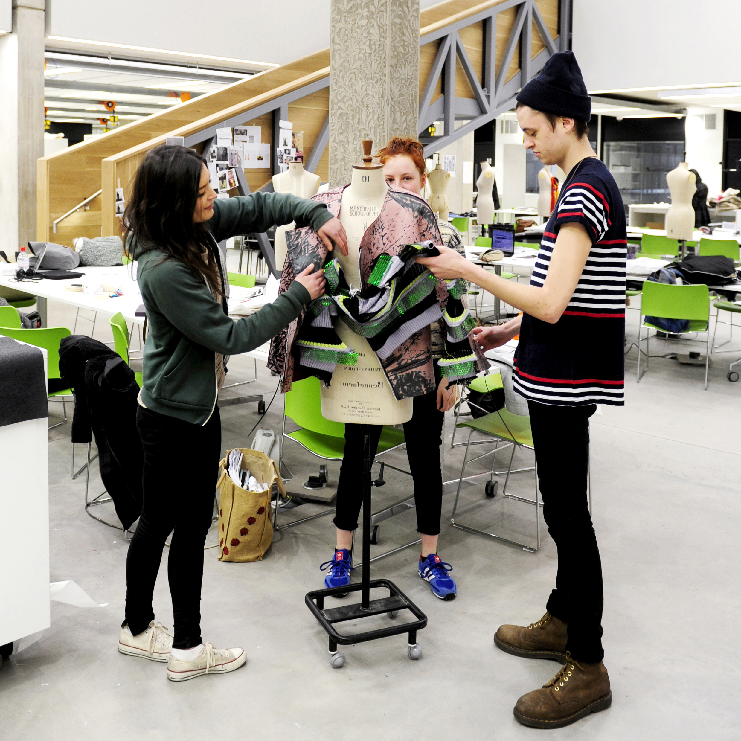 A group of INTO students design and create a dress on mannequin