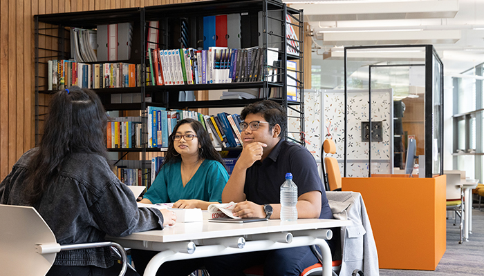 International students studying in the library at INTO Exeter