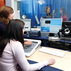 Group of students working in a sound studio Group of students working in a sound studio