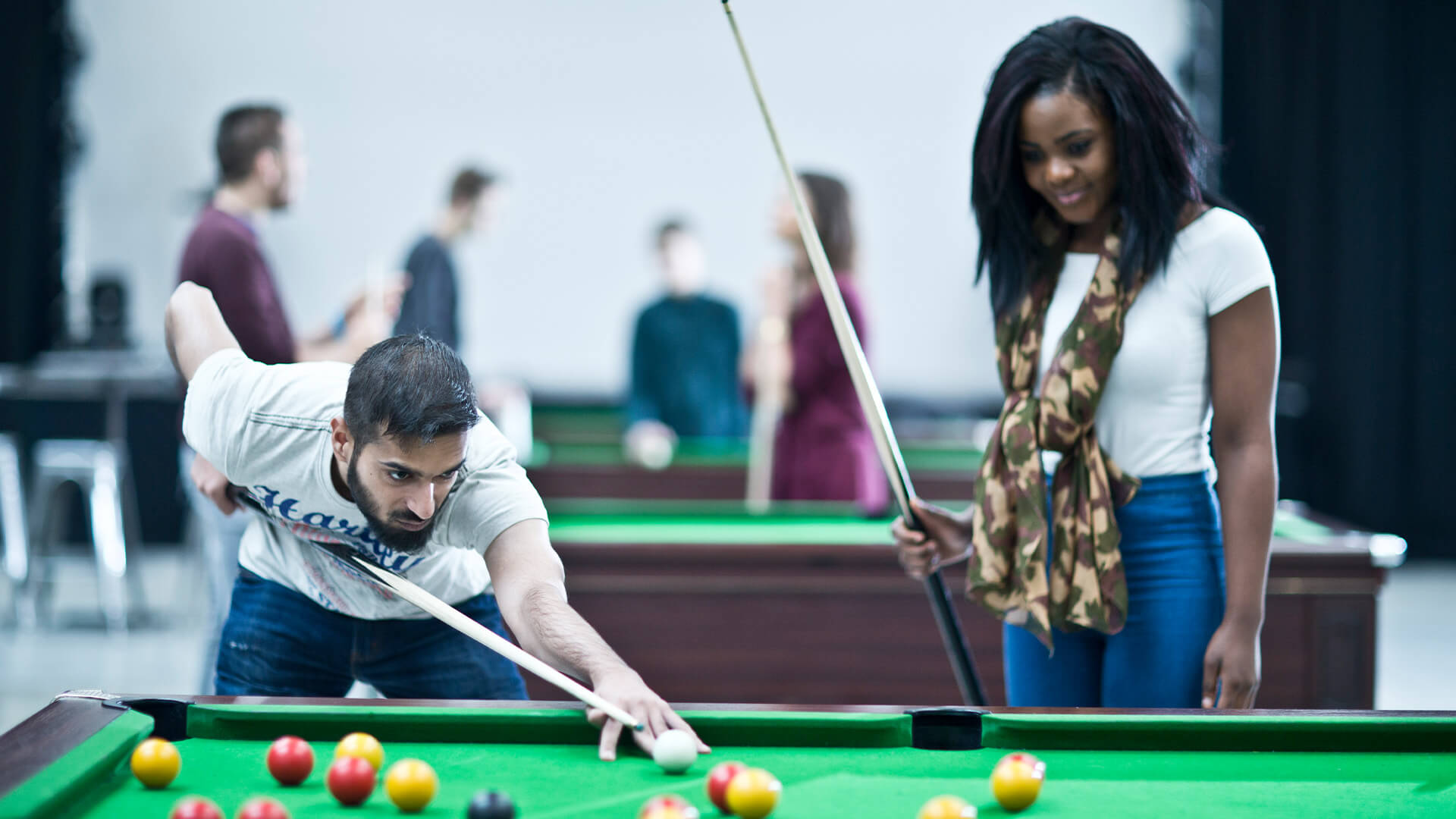 Students playing pool in a breakout area on Manchester Metropolitan University campus