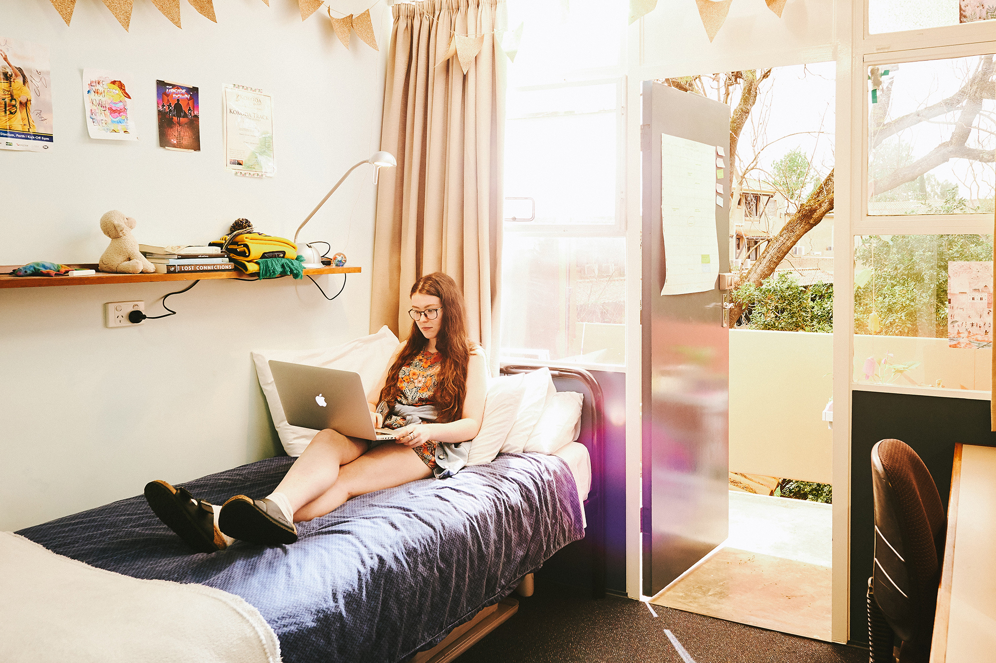 UWA Residential Colleges - Student in their room at Trinity College