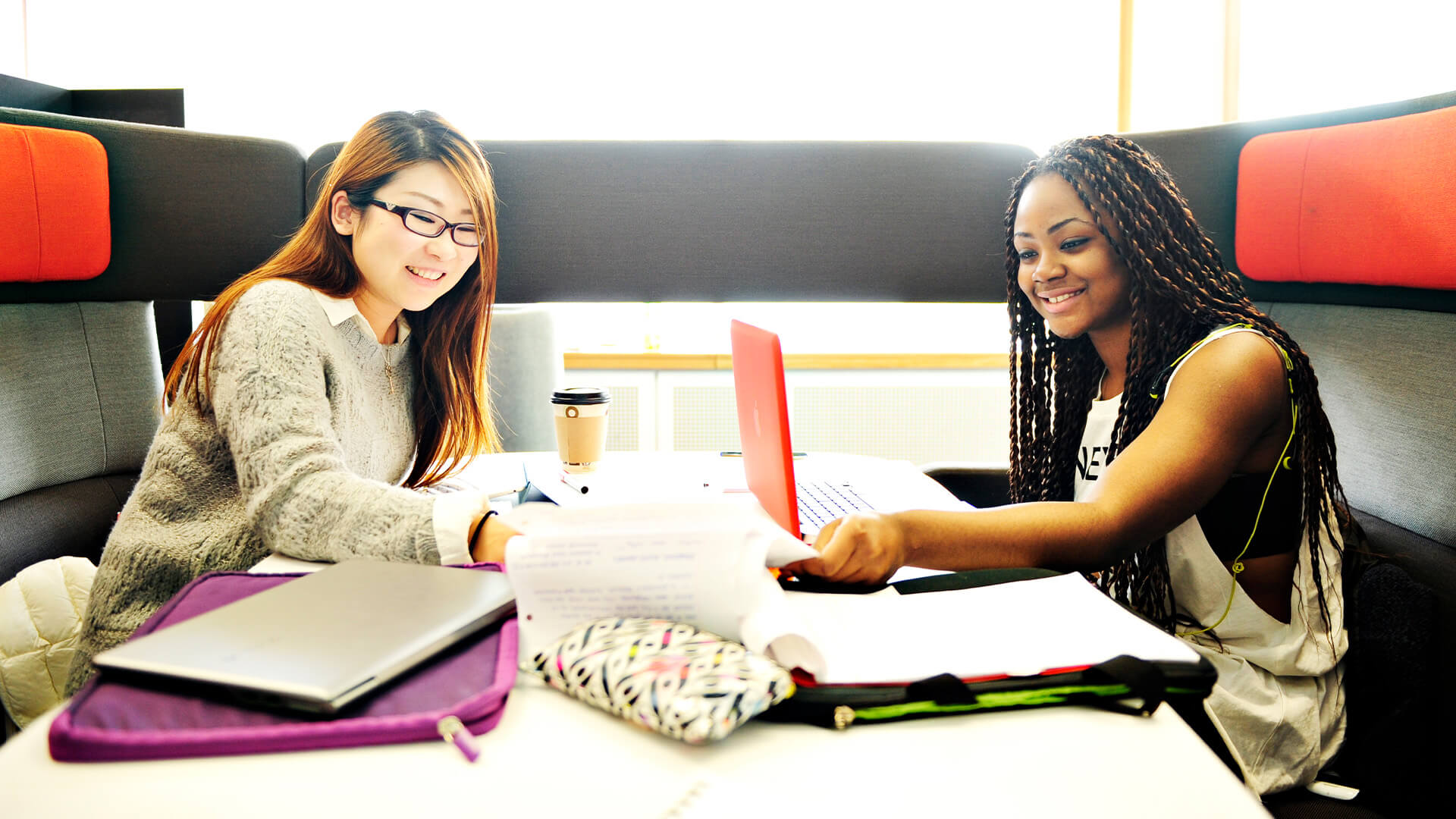 Students studying in a breakout area on-campus at the University of Manchester