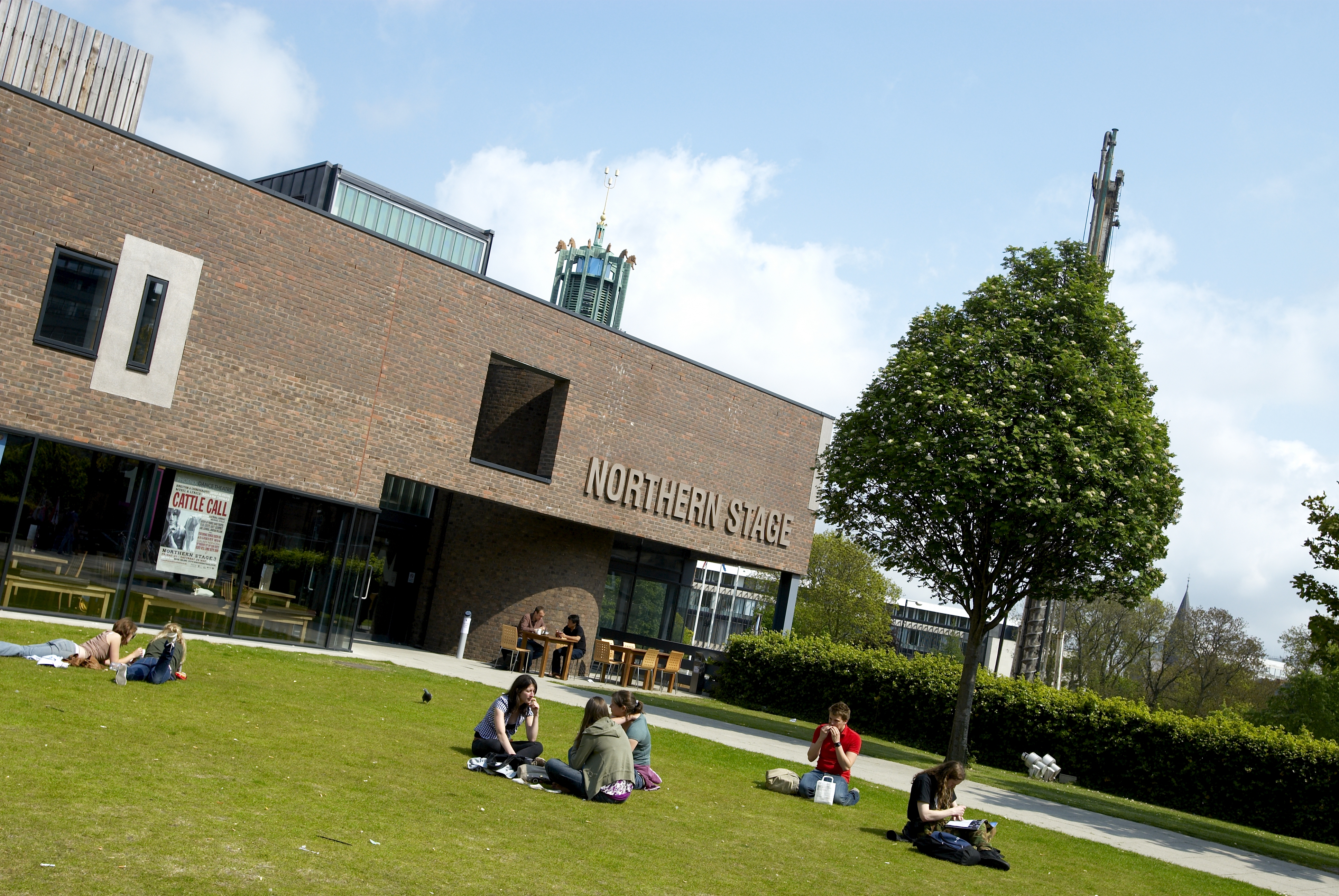 Students sat in front of Northern Stage theatre on campus