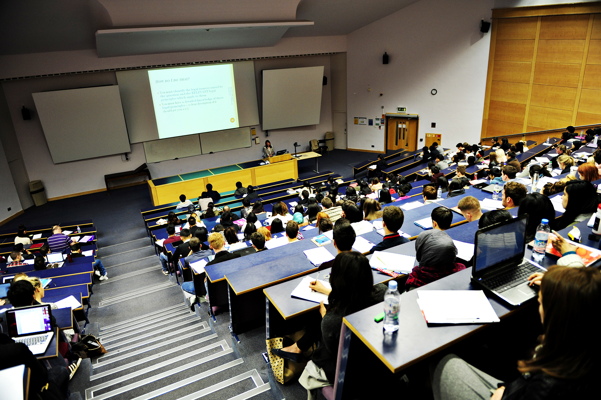 Students watch a presentation in the lecture hall