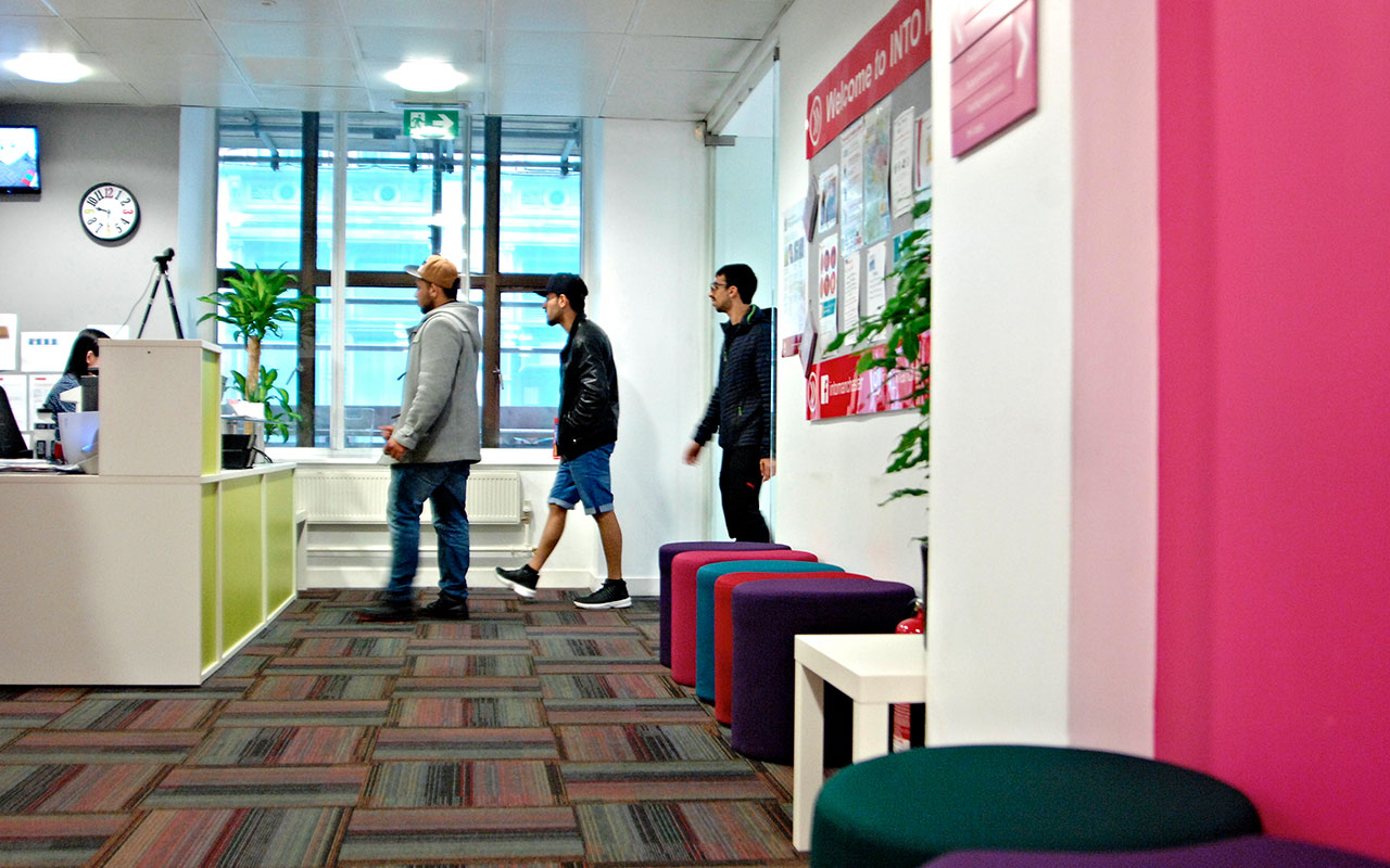 Students walking up to the welcome desk at INTO Manchester Choice Centre
