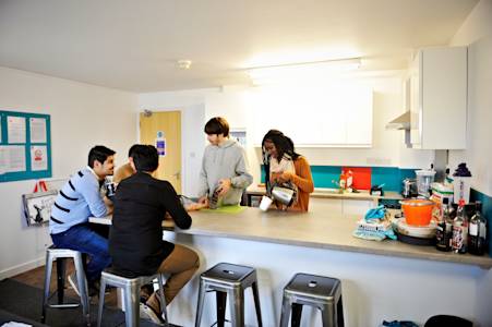 Students socialising in a shared kitchen at Liberty Park student residences at GCU Students socialising in a shared kitchen at Liberty Park student residences at GCU