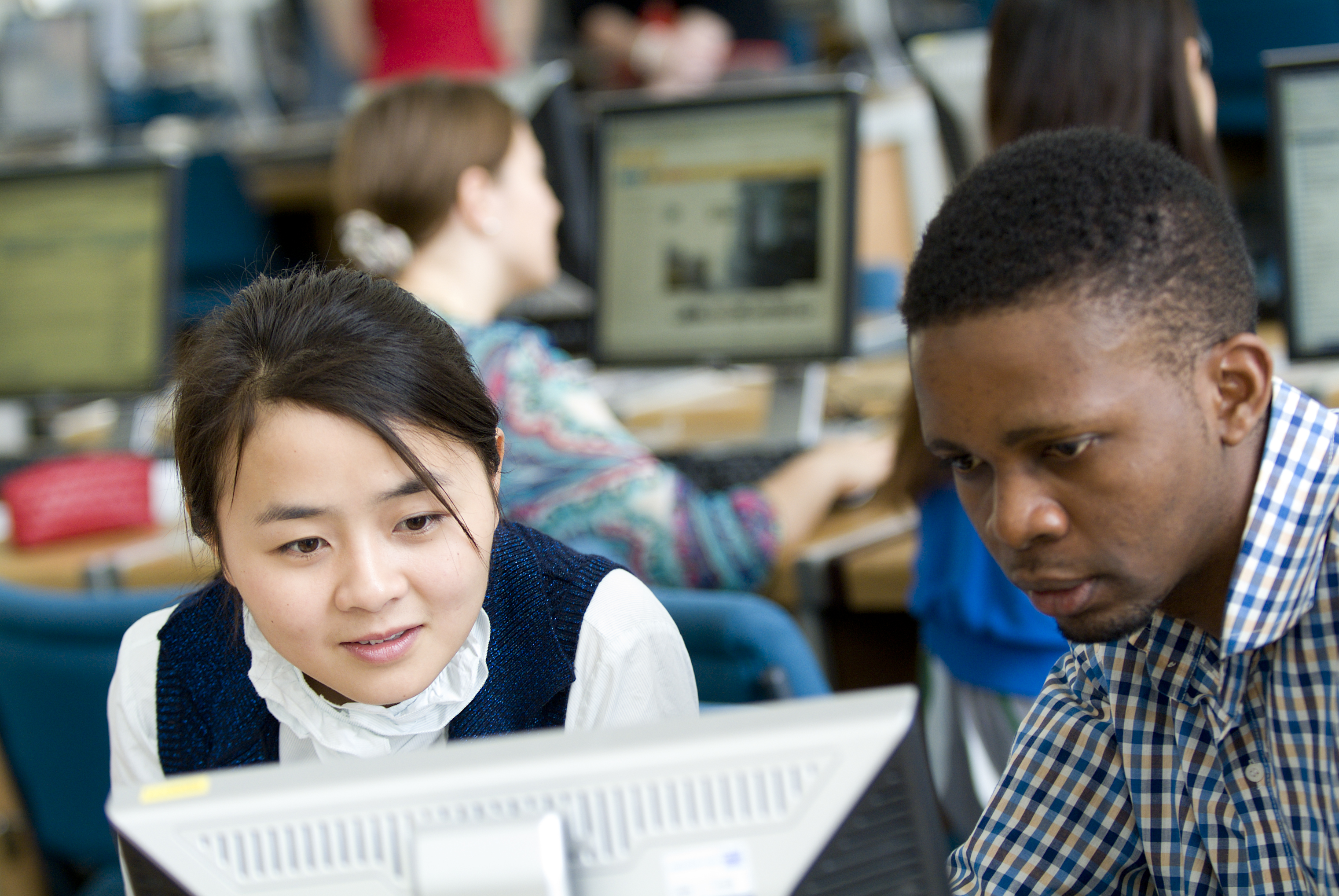 Two international students in computer lab