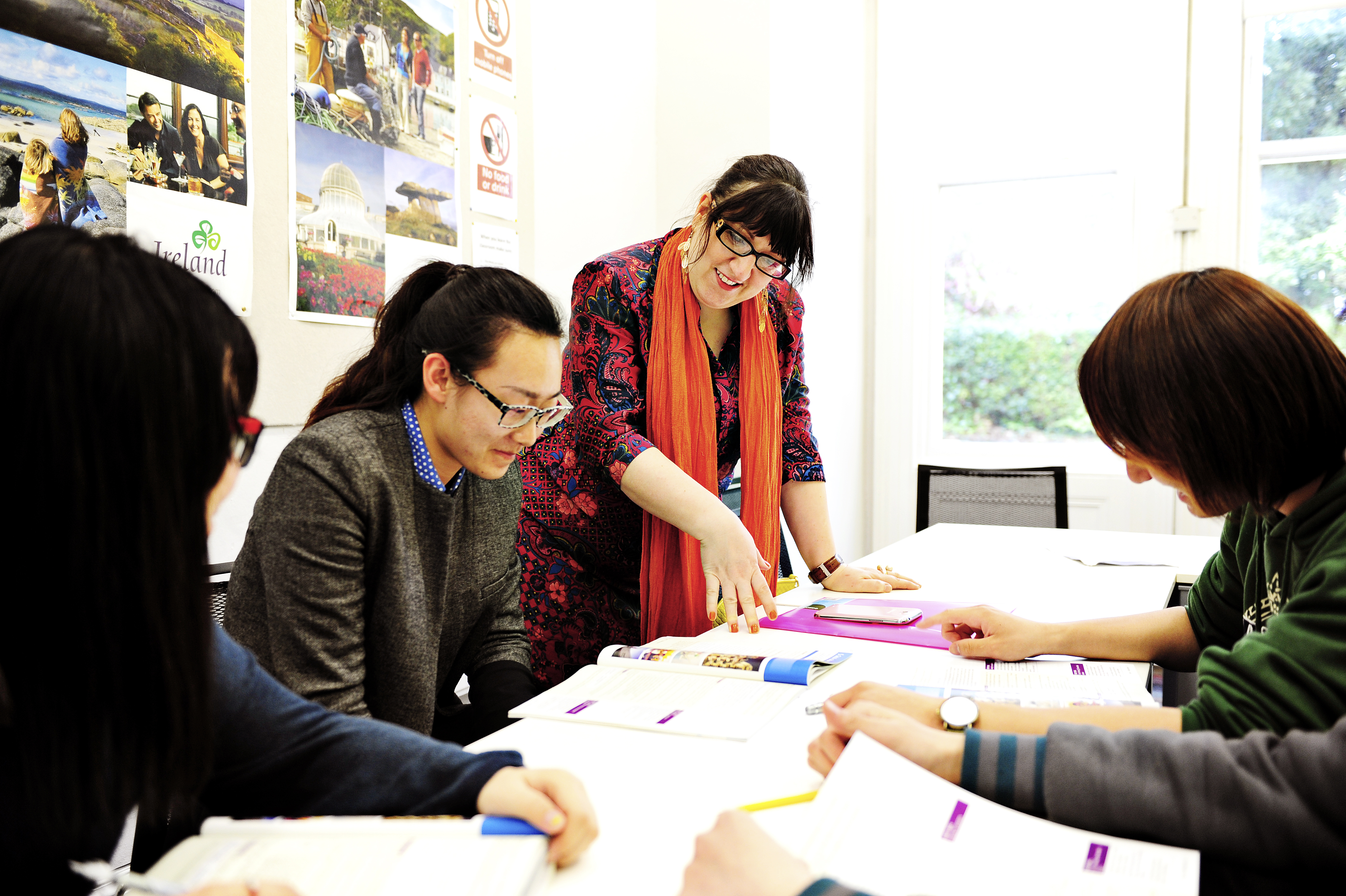 INTO International students learning as a group from textbooks