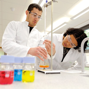 Students fill conical flask in science laboratory at University of Exeter Students fill conical flask in science laboratory at University of Exeter