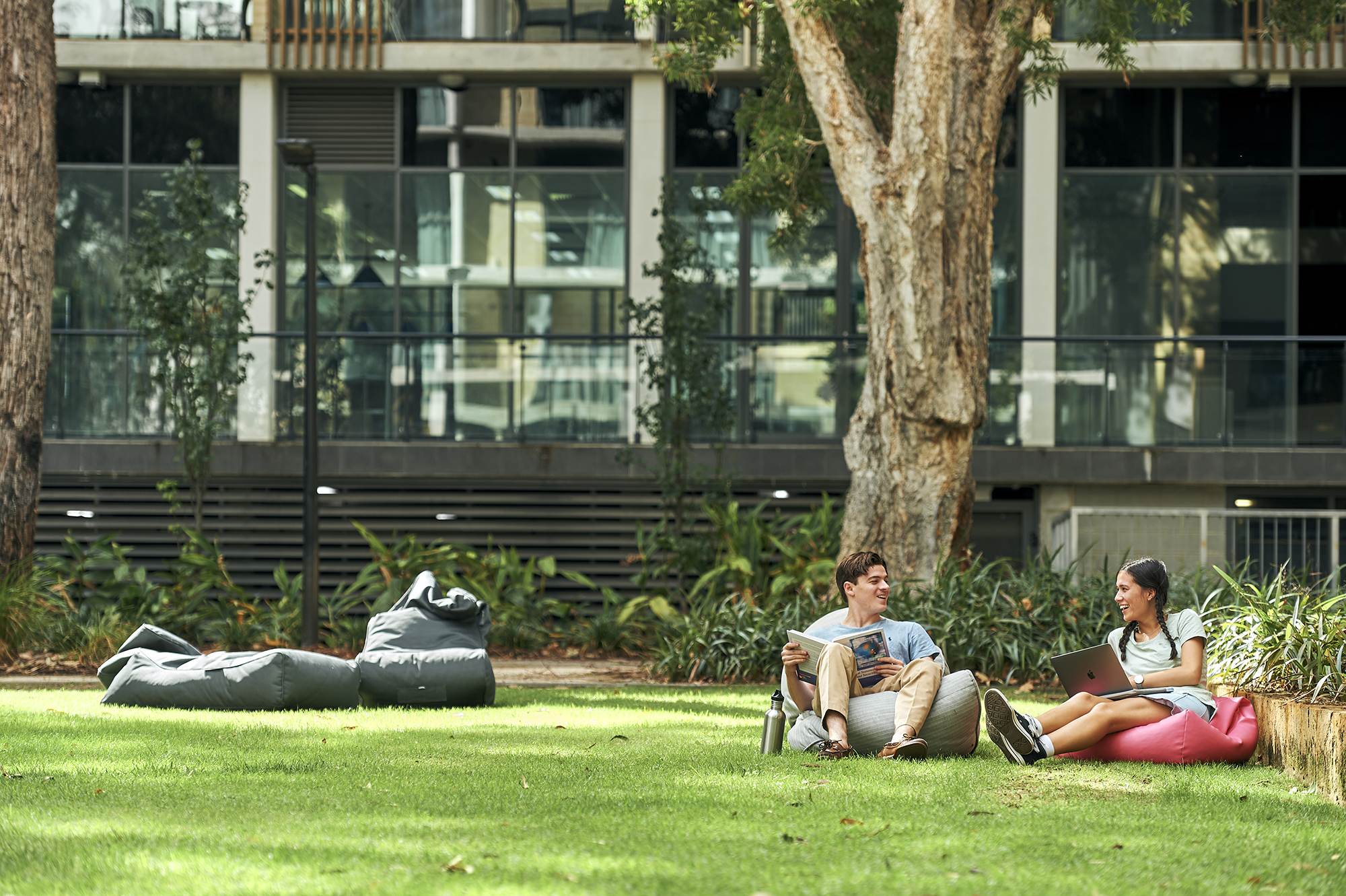 UWA Residential Colleges - students sitting outside on bean bags