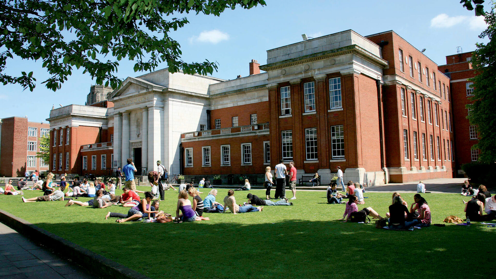 Photo of students on The University of Manchester campus lawn