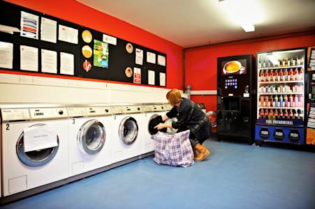 Student using laundry facilities at Liberty Park at INTO GCU Student using laundry facilities at Liberty Park at INTO GCU